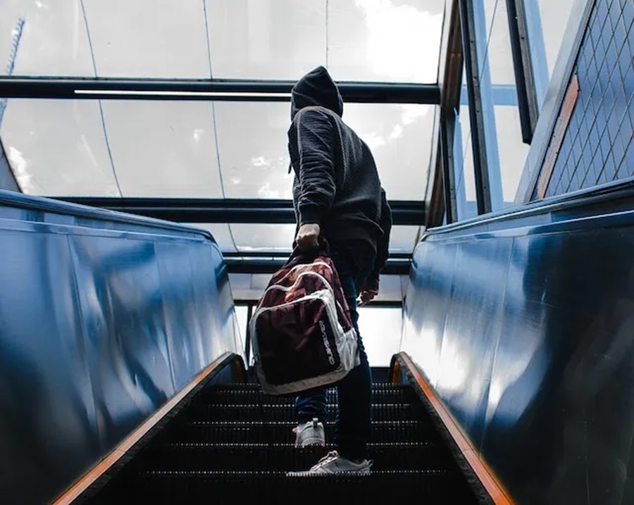 man riding escalator